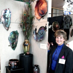 Artist Lynne Anderson in booth at art show